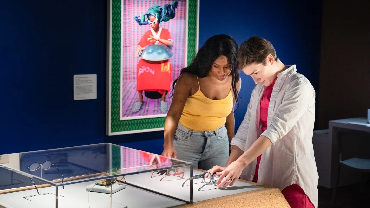 2 people examining a museum exhibition